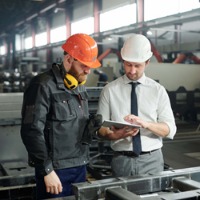 Two workers looking at tablet