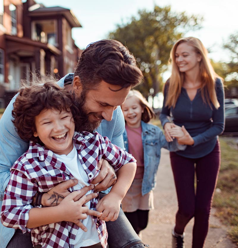 Family waling down a street