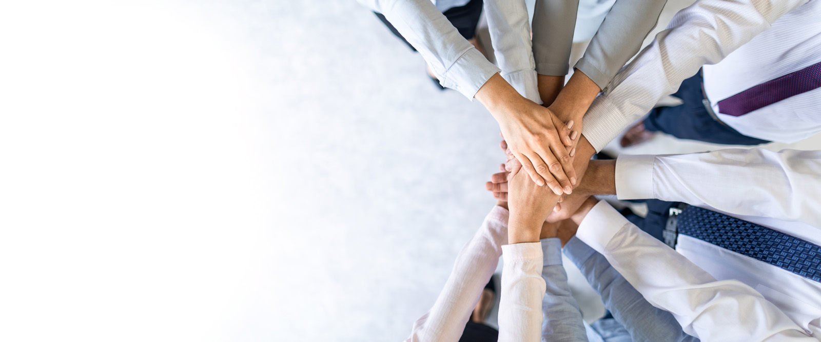 Image of people putting their hands together