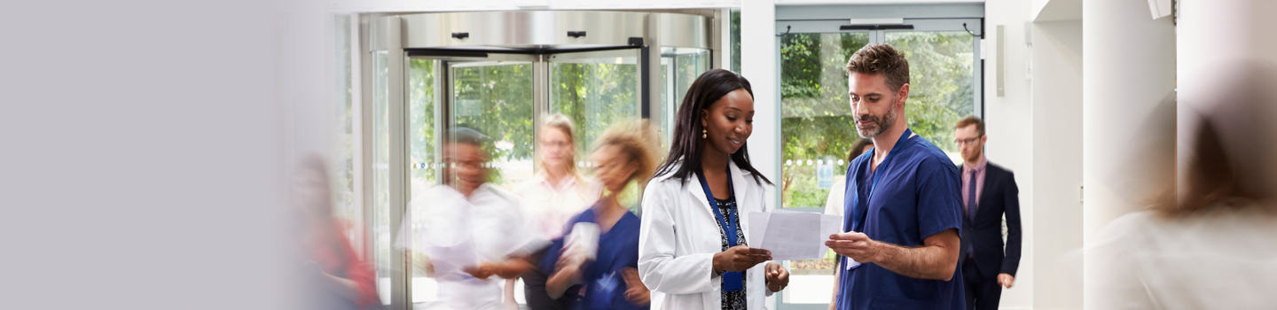 Healthcare employees in lobby looking at papers