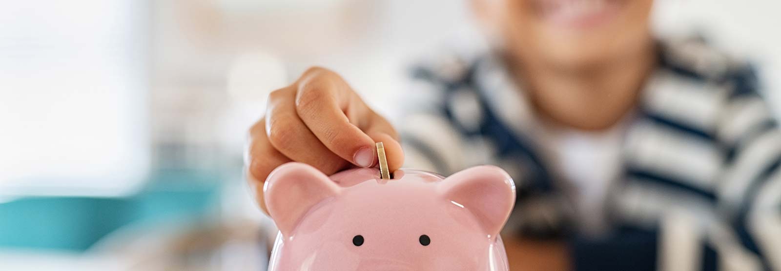 Little boy and a piggy bank