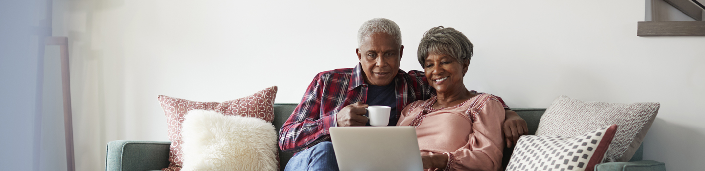 couple on couch with laptop