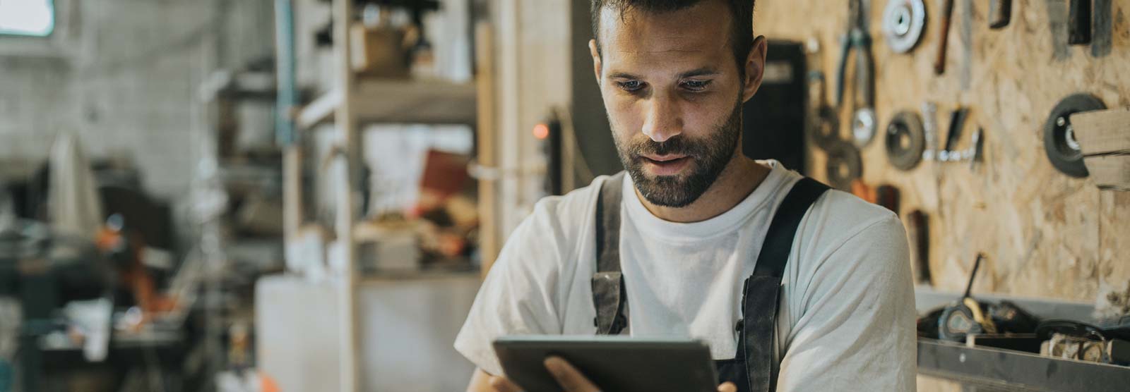 Man using a smart tablet in his shop