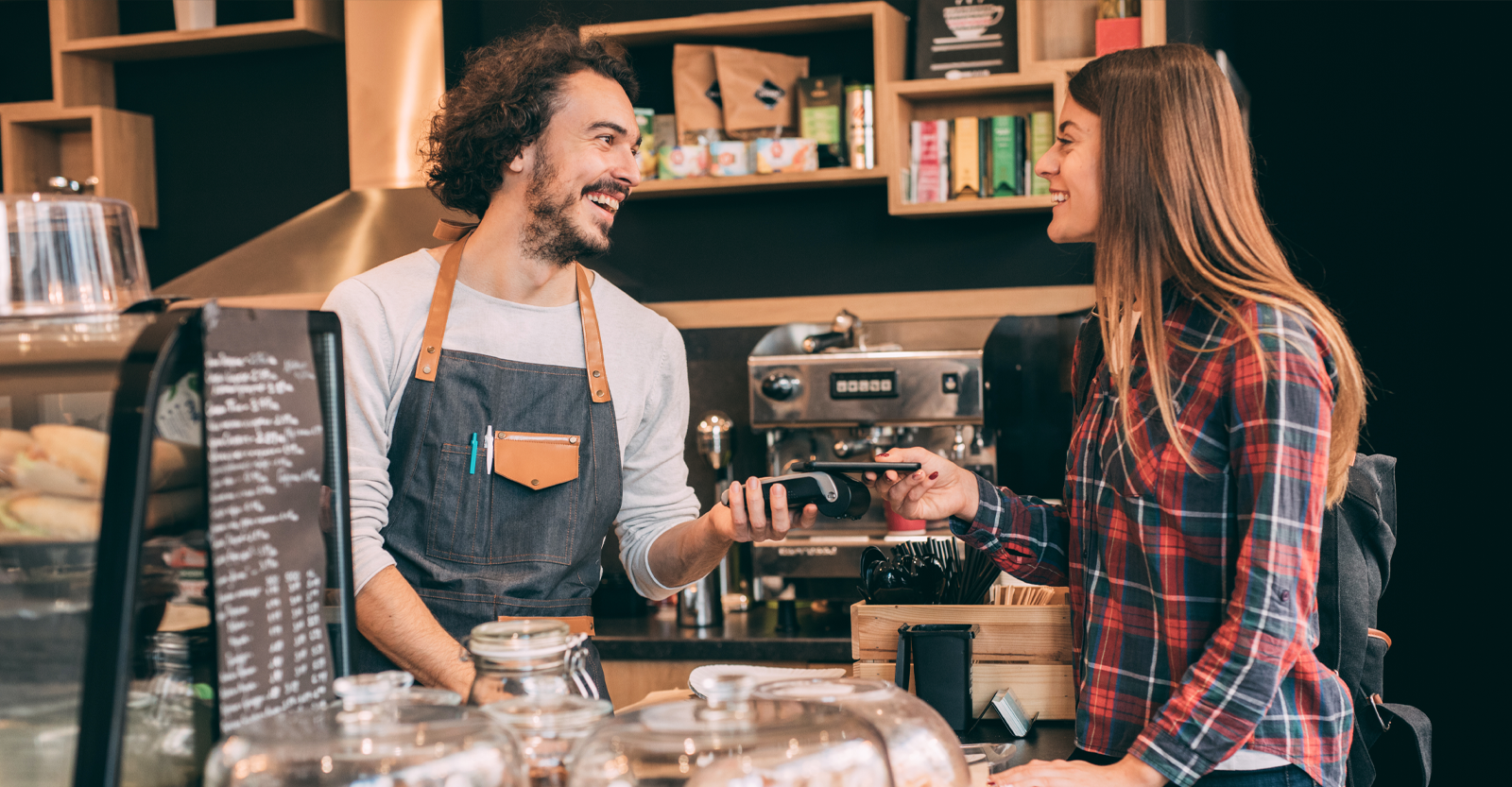 Coffee shop employee takes payment through non-contact means