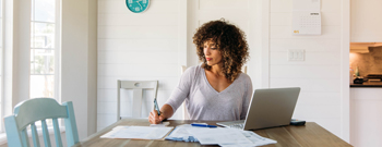 Woman with laptop paying bills