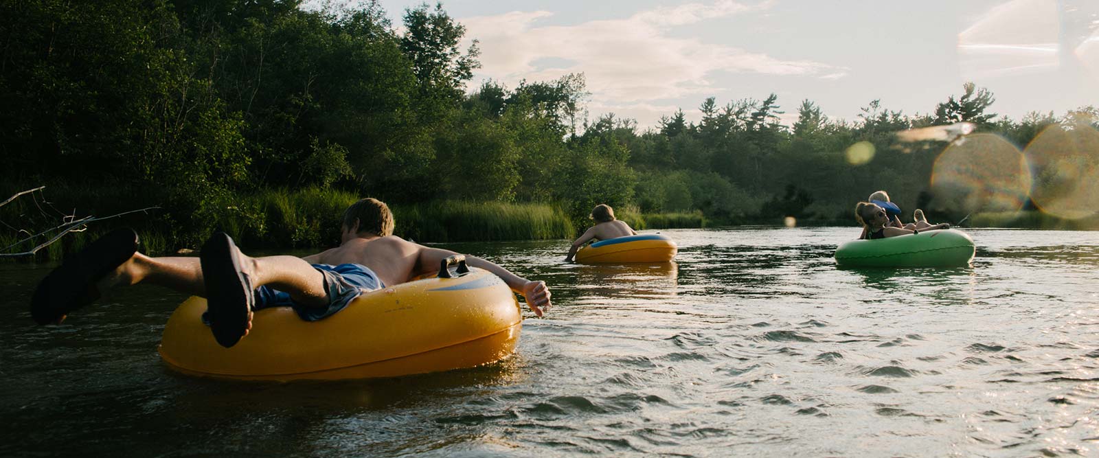 Kids riding tubes down a river