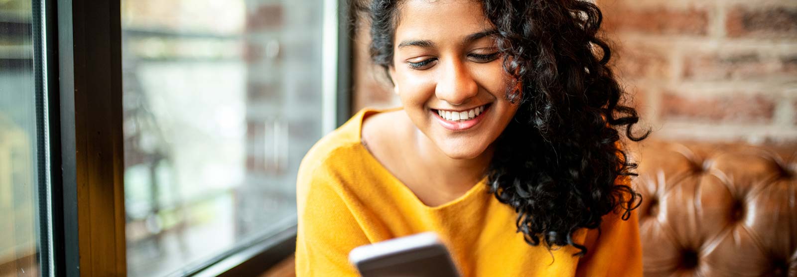 Lady using a smartphone in a restaurant