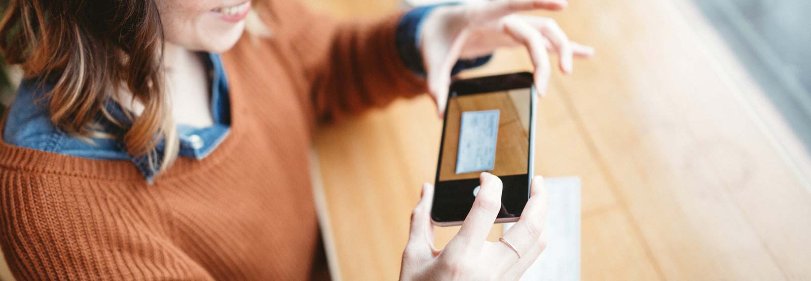 Lady making a mobile deposit with smartphone