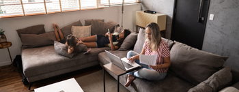Small image of mom with daughters on couch