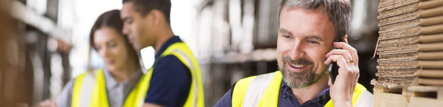 Man in warehouse talking on cellphone