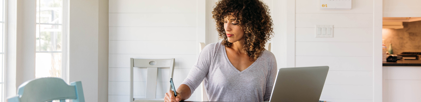 Woman with laptop paying bills